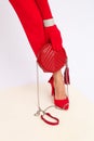 Fashion unrecognizable Lady in retro red pants, shoes and gloves.   Studio lookbook. Trendy Accessories clutch and bracelets. Royalty Free Stock Photo