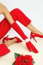 Fashion unrecognizable Model in red pants and shoes. Minimalist elegant details style. Retro gloves and bracelets. Lookbook