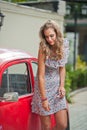 Fashion urban portrait of beautiful model with long legs on the street. Blonde Girl with short dress Royalty Free Stock Photo