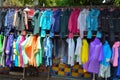 Fashion waterproof colorful raincoat hanging on hanger at clothes shop in the road side