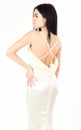 Fashion wedding concept. Woman in elegant white dress with nude back, white background. Fashion model demonstrate Royalty Free Stock Photo