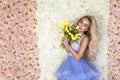 Fashion wedding dress model with a bouquet of tulips. Beautiful bride model in blue amazing wedding dress. Beauty young woman on Royalty Free Stock Photo