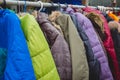 Fashion winter coats hanged on a clothes rack.