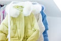 Fashion winter coats hanged on a clothes rack Royalty Free Stock Photo