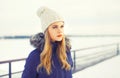 Fashion winter portrait blonde woman wearing a jacket and knitted hat Royalty Free Stock Photo