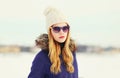 Fashion winter portrait blonde woman wearing jacket knitted hat sunglasses Royalty Free Stock Photo