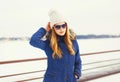 Fashion winter portrait pretty blonde woman wearing jacket hat sunglasses Royalty Free Stock Photo