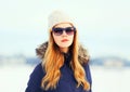 Fashion winter portrait pretty blonde woman wearing a jacket hat sunglasses Royalty Free Stock Photo