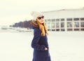 Fashion winter pretty blonde woman wearing a jacket hat sunglasses Royalty Free Stock Photo