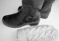 Fashion winter women`s shoes-black leather boots and knitted wool hat on a white background, the concept of buying warm clothes Royalty Free Stock Photo