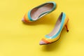 Fashion woman accessories set. Trendy fashion colorful shoes heels. Yellow pastel color background, top view and copy space. Royalty Free Stock Photo