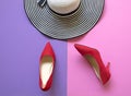 Fashion woman accessories set. Trendy fashion red shoes heels and big hat. Colorfull background. Royalty Free Stock Photo