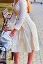 Fashion woman in autumn-spring dress on city street. Royalty Free Stock Photo