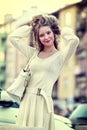 Fashion woman in autumn spring white dress on city street. Royalty Free Stock Photo