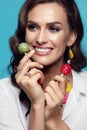 Fashion. Woman With Beauty Face Makeup Holding Candy. Royalty Free Stock Photo