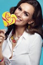 Fashion. Woman With Beauty Face Makeup Holding Candy. Royalty Free Stock Photo
