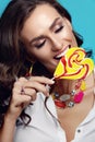 Fashion. Woman With Beauty Face Makeup Holding Candy. Royalty Free Stock Photo