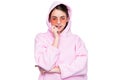 Fashion woman biting nails in casual pink hoodie hooded sweatshirt isolated on white