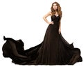 Fashion Woman in Black Dress flying on Wind. Beauty Model with Curly Long Hair in Evening Gown. Elegant Lady dancing over White Royalty Free Stock Photo