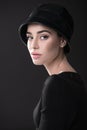 Fashion woman. Black and white portrait of beautiful young elegant lady in black dress and hat. Vintage styling. Beauty, fashion Royalty Free Stock Photo