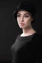 Fashion woman. Black and white portrait of beautiful young elegant lady in black dress and hat. Vintage styling. Beauty, fashion Royalty Free Stock Photo