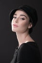 Fashion woman. Black and white portrait of beautiful young elegant lady in black dress and hat. Vintage styling. Beauty, fashion Royalty Free Stock Photo