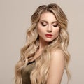 Fashion woman blond with long wavy hair. Woman with beautiful makeup