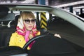 Fashion woman with blonde hair and sexy style driving sport car. young rich girl in yellow jacket and handkerchief in cabriolet Royalty Free Stock Photo