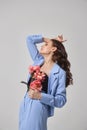 Fashion woman in blue suit with pink flowers, beauty face portrait. Art studio portrait of a young woman on a white background, Royalty Free Stock Photo