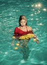 Fashion woman body. Woman relax in spa pool. Summer vacation and travel to ocean. Vitamin in banana at girl sitting near Royalty Free Stock Photo