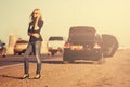 Fashion woman calling on cell phone next to broken car Royalty Free Stock Photo