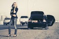 Fashion woman calling on cell phone next to broken car Royalty Free Stock Photo