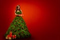 Fashion Woman in Christmas Tree Dress, Model hold Xmas Present Royalty Free Stock Photo