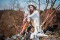 Fashion woman in country style sitting on the canyon rock