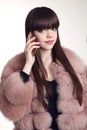 Fashion woman in fur coat, lady portrait talking on cell phone i Royalty Free Stock Photo