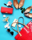 Beautiful  Woman Accessories Red Wallet with money euro Red handbag  perfume black Sunglass And Silver Shoes on High Heels on Blue Royalty Free Stock Photo