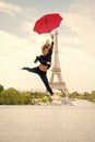 Fashion woman jump with umbrella. Happy woman travel in paris, france. Girl with beauty look at eiffel tower. Travelling Royalty Free Stock Photo