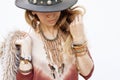Fashion woman portrait, hands with boho chic bracelets, leather necklace and hat