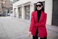 Fashion woman in a red coat stands in the city. Businessman. Copycpase Royalty Free Stock Photo