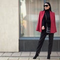 Fashion woman in a red coat stands in the city. Businessman. Copycpase