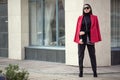 Fashion woman in a red coat stands in the city. Businessman. Copycpase Royalty Free Stock Photo