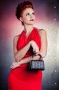 Fashion woman red dress with litle bag. Metal wall background Royalty Free Stock Photo