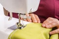 Fashion woman sews with sewing machine Royalty Free Stock Photo