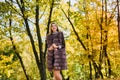Fashion woman. Smiling girl in fur coat posin in autumn park with trees and ivy Royalty Free Stock Photo