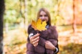 Fashion woman. Smiling girl in fur coat posin in autumn park with trees and ivy Royalty Free Stock Photo