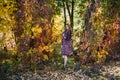 Fashion woman. Smiling girl in fur coat posin in autumn park with trees and ivy Royalty Free Stock Photo