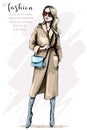 Fashion woman in stylish coat. Beautiful young woman with bag. Elegant girl in fashion clothes.