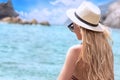 Fashion woman in summer hat relaxing on the beach. Royalty Free Stock Photo