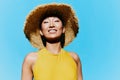 Fashion woman summer trendy eyes hat portrait yellow beauty swimsuit smile Royalty Free Stock Photo