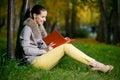 Fashion woman using a tablet computer outside in evening park Royalty Free Stock Photo